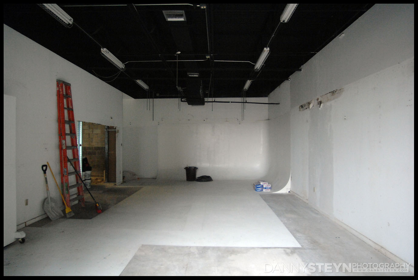 The empty main Portrait Studio with cyc wall and newly discovered leak and drywall rot!