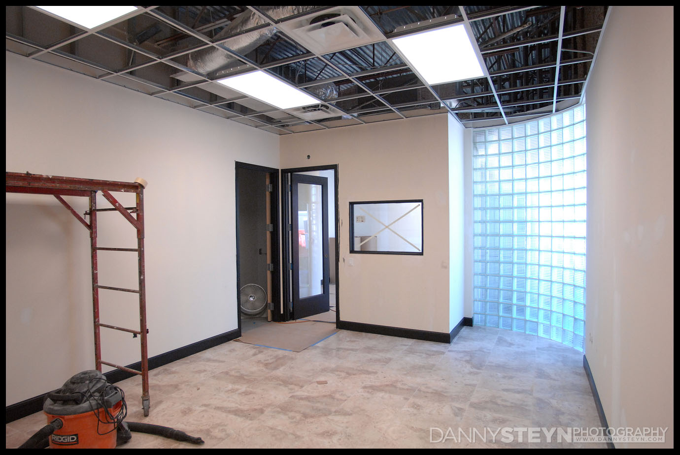 Editing room - new photography studio - black baseboards and glass brick wall